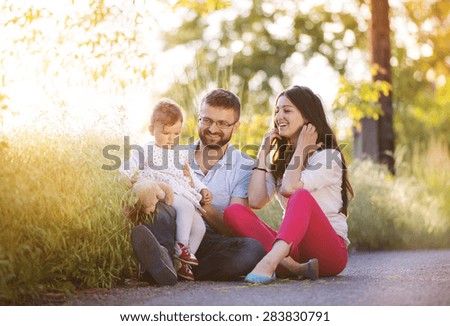 Happy young family having fun outside in spring nature