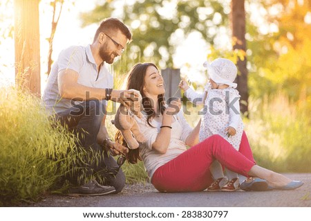 Happy young family having fun outside in spring nature