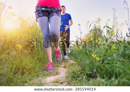 Young runners training outside in spring nature