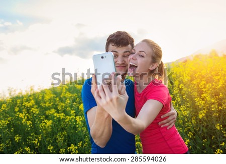 Young runners training outside in spring nature taking selfie