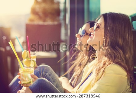 Two beautiful women having fun in a bar