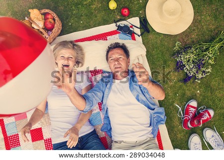 Beautiful seniors having a picnic in nature