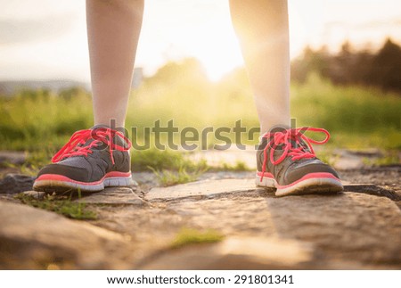 Feet of a young runner training outside in spring nature