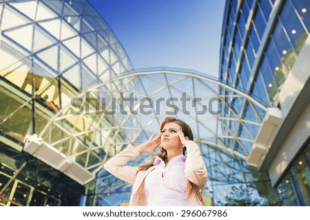 Attractive young business woman with shopping bags in front of the mall