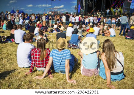 Group of beautiful teens at concert at summer festival