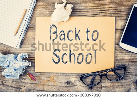 Desktop mix with Back to school sign on a wooden office table background. View from above.