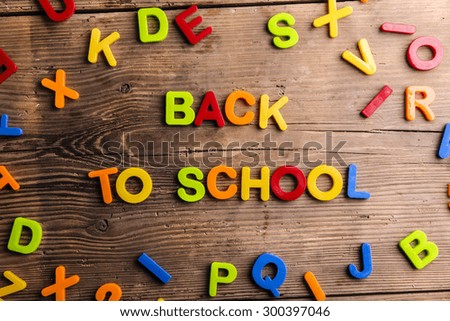 Back to school sign formed from colorful plastic letters.