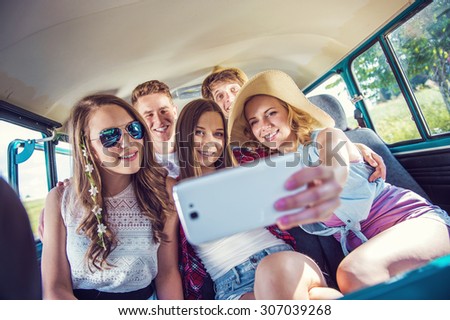 Young hipster friends on a road trip on a summers day