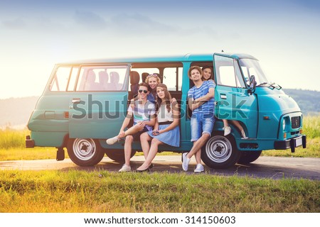 Young hipster friends on road trip on a summer day