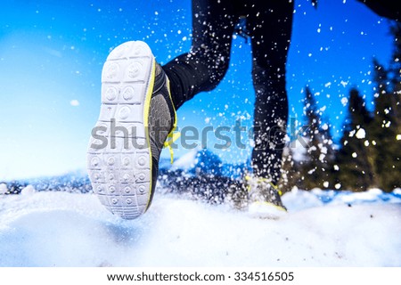 Legs of a young runner outside in winter nature