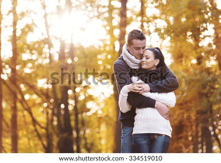 Beautiful couple in love on a walk in autumn forest