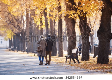 Active seniors on a walk in autumn town