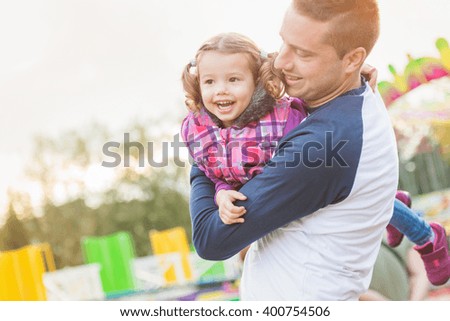 Father and daughter having fun, fun fair, amusement park