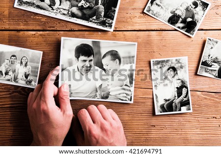 Fathers day composition. Black-and-white pictures, studio shot. Young father is enjoying time with his child. Father and son at home. Handsome father with little boy. Happy fathers day.