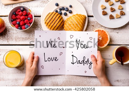 Fathers day composition. Greeting card and breakfast meal. Fathers day. Concept for fathers day celebration. Best father. Child and father concept. We love you daddy text.