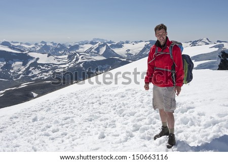 Man on the summit of Glittertind mountain (Jotunheimen National Park, Norway)