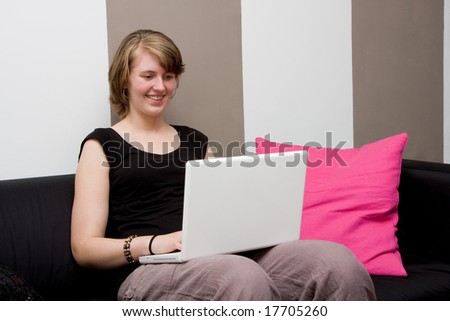 Young woman with a laptop on the couch