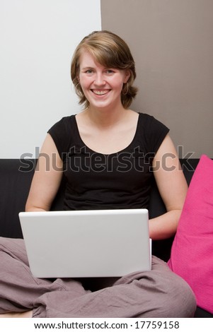 Young woman with a laptop on the couch