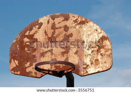 Sad, Old, Rusty Basketball Goal Without Net Against Blue Sky