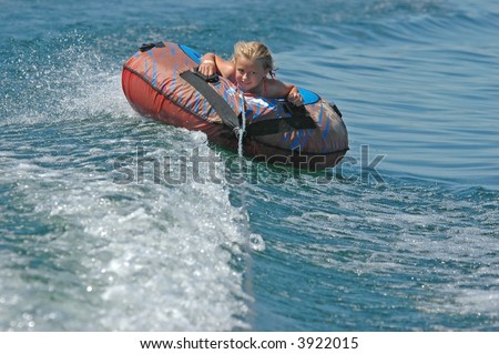 Girl Water Tubing in Wake of Boat