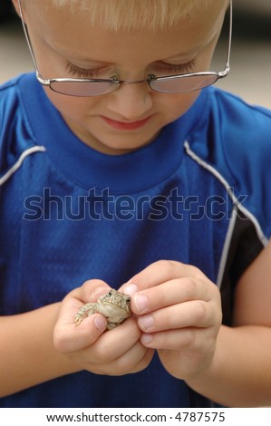 Young Boy Studies Toad in Hand