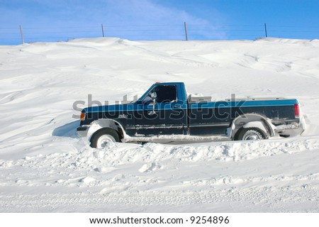 SOUTHWEST IOWA - MARCH 1, 2007: Older pickup truck is stuck in a snow drift after a blizzard March 1, 2007