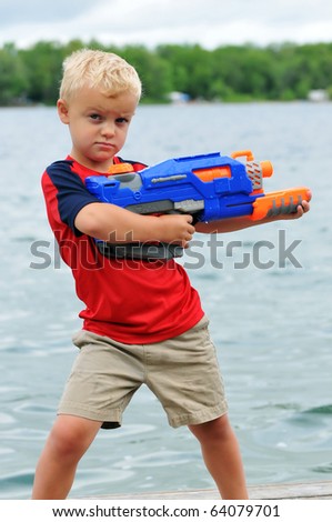 Young Boy with Attitude Holds a Water Gun