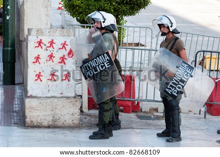 ATHENS, GREECE - JULY 8: Greek riot police stand poised during demonstration near Parliament building In Syntagma Square, July 8, 2011.