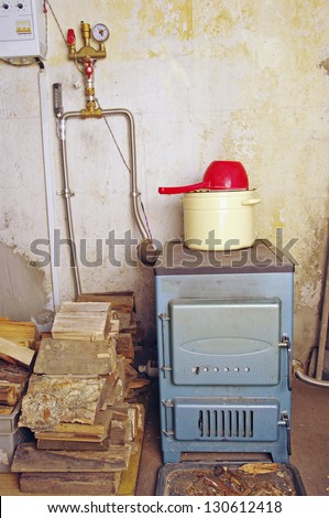 steel water boiler with a stove plate pan and ladle  at home