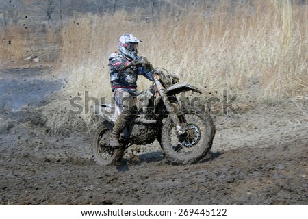 Off-road rider is jumping against a steaming ground   Nakhodka Russia 04.12.2015