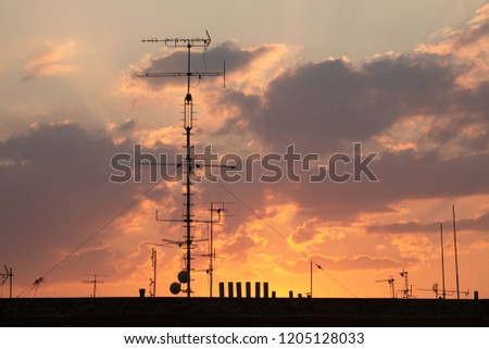 Television antennas on the roof pictured at sunset in Prague, Czech Republic.