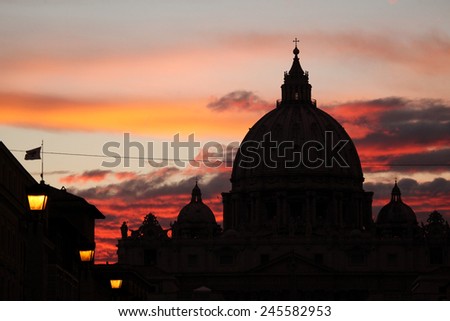 Sunset over the dome of Saint Peter\'s Basilica in Vatican City in Rome, Lazio, Italy.