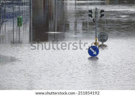 PRAGUE, CZECH REPUBLIC - JUNE 4, 2013: Flooded crossroad with traffic lights and a keep right traffic sign partially flooded by the swollen Vltava River in Prague, Czech Republic.