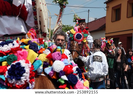 VLCNOV, CZECH REPUBLIC - MAY 26, 2013: Young men dressed in Moravian folk costume ride decorated horses to perform the Recruits during the Ride of the Kings festival in Vlcnov, Moravia, Czech Republic