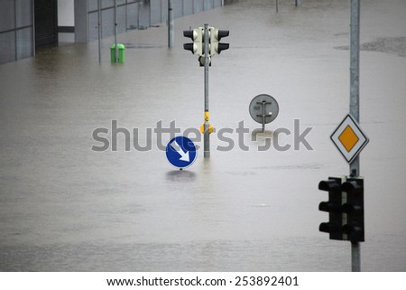 PRAGUE, CZECH REPUBLIC - JUNE 3, 2013: Flooded crossroad with traffic lights and a keep right traffic sign partially flooded by the swollen Vltava River in Prague, Czech Republic.