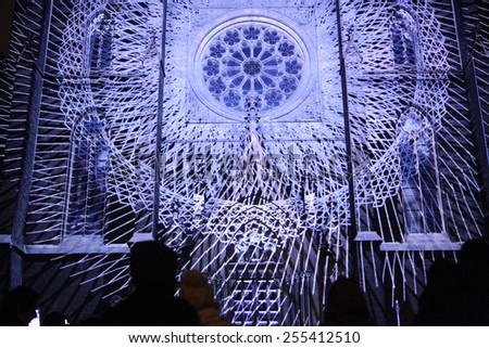 PRAGUE, CZECH REPUBLIC - OCTOBER 17, 2013: People watch a projection mapping by Czech art group The Macula on the facade of St Ludmila Church during the Signal Festival in Prague, Czech Republic.