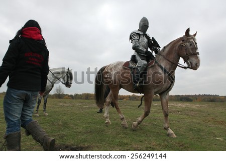 MILOVICE, CZECH REPUBLIC - OCTOBER 23, 2013: Actor dressed as a medieval knight rides a horse during the filming of the new movie The Knights near Milovice, Czech Republic.