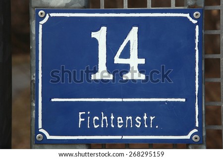 MUNICH, GERMANY - MARCH 3, 2012: Traditional blue street sign at Fichtnerstrasse 14 in Munich, Bavaria, Germany.
