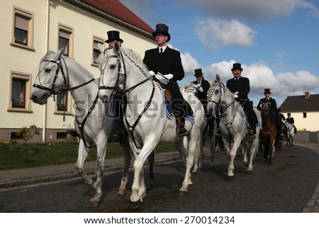 RALBITZ, GERMANY - APRIL 8, 2012: Easter Riders attend the Easter ceremonial equestrian procession in the Lusatian village of Ralbitz near Bautzen, Upper Lusatia, Saxony, Germany.