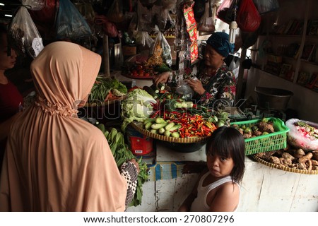 JAKARTA, INDONESIA - AUGUST 17, 2011: Vendor sells vegetables at the Pasar Pramuka Market in Jakarta, Central Java, Indonesia.