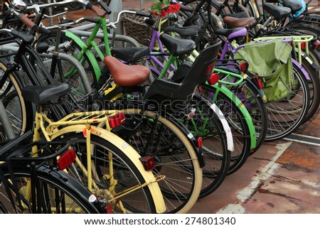 AMSTERDAM, NETHERLANDS - AUGUST 9, 2012: Colourful bicycles parked at the bicycle parking station next to the Central railway station in Amsterdam, Netherlands.