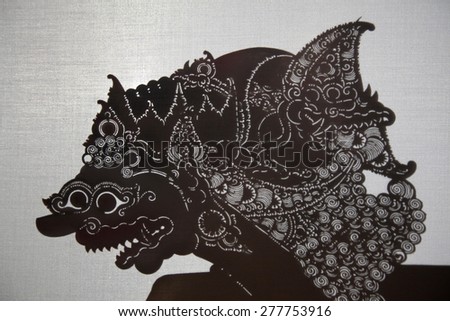 YOGYAKARTA, INDONESIA - AUGUST 14, 2012: Traditional Indonesian shadow puppet theatre wayang kulit performs on street during a religious festival in Yogyakarta, Central Java, Indonesia.
