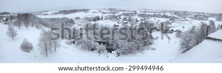 Russian winter. Snow-covered landscape with the village of Kruppsk next to the Izborsk Fortress near Pskov, Russia.