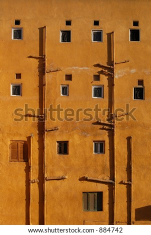 Windows of a yellow-painted house in Luxor, Egypt