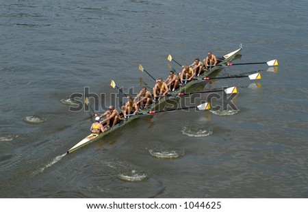 Rowing team rowing ahead during a boat-race on the River Vltava in Prague, Czech Republic.