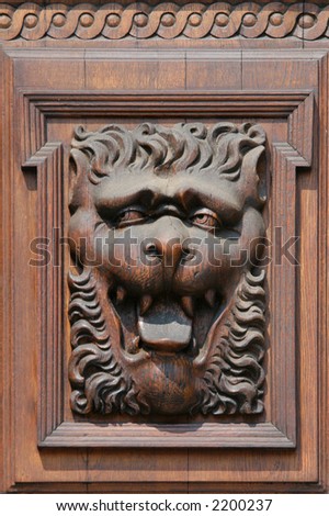 Medieval wooden sculpture of a fabulous monster on the gate of the Old Town Hall in Prague, Czech Republic.