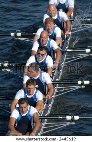 Rowing team rowing ahead during a boat-race on the River Vltava in Prague, Czech Republic