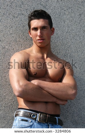 Shirtless muscular male model in front of the stonewall