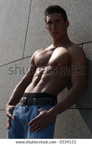 Shirtless muscular male model in front of the stonewall