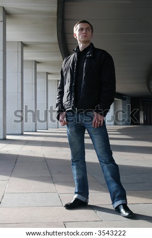 Young man walking on the colonnade